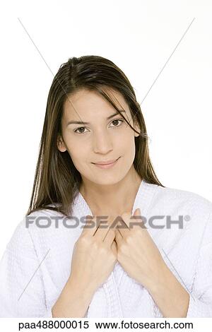 Stock Photography - Woman wearing bathrobe, holding onto edges of collar, smiling at camera. Fotosearch