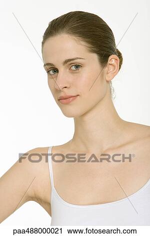 Woman with hair in bun, wearing white tank top, portrait View Large Photo Image Stock Image - Woman with hair in bun, wearing white tank top, portrait. Fotosearch