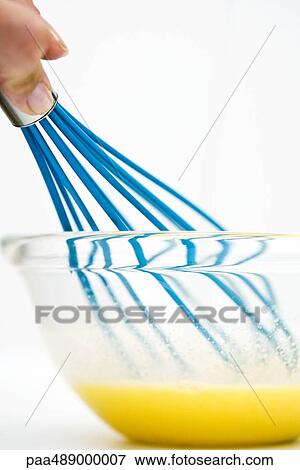 Hand mixing eggs with whisk, cropped, low angle view View Large Photo Image Stock Photo - Hand mixing eggs with whisk, cropped, low angle view. Fotosearch