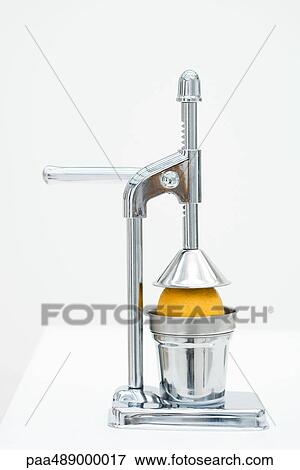 Orange in citrus press, close-up View Large Photo Image Stock Photo - Orange in citrus press, close-up. Fotosearch