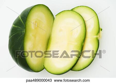 Stock Image - Sliced squash (zapallito redondo), close-up, high angle view. Fotosearch