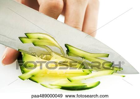 Stock Photo - Woman chopping winter squash with knife, cropped view of hand. Fotosearch