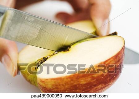 Woman cutting apple with knife, close-up, cropped view of hand View Large Photo Image Stock Image - Woman cutting apple with knife, close-up, cropped view of hand. Fotosearch