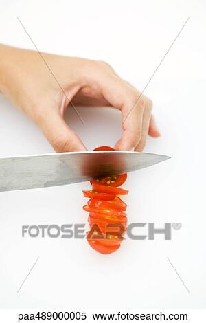 Woman cutting tomato with knife, high angle view, cropped View Large Photo Image Stock Photography - Woman cutting tomato with knife, high angle view, cropped. Fotosearch