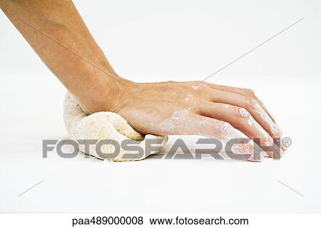 Stock Photo - Woman kneading dough, cropped view of hand. Fotosearch