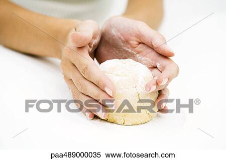 Stock Photography - Woman kneading dough, cropped view of hands. Fotosearch