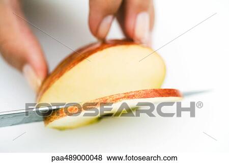Woman slicing apple with knife, cropped view of hand View Large Photo Image Stock Photo - Woman slicing apple with knife, cropped view of hand. Fotosearch