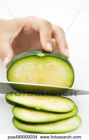 Woman slicing squash (zapallito redondo) with knife, cropped view of hand View Large Photo Image Picture - Woman slicing squash (zapallito redondo) with knife, cropped view of hand. Fotosearch