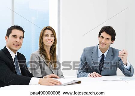 Business associates having meeting, all smiling at camera View Large Photo Image Stock Photograph - Business associates having meeting, all smiling at camera. Fotosearch