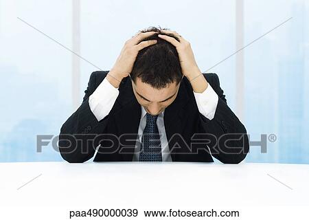 Businessman holding head View Large Photo Image Stock Photo - Businessman holding head. Fotosearch