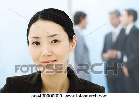Businesswoman, portrait, colleagues standing in background View Large Photo Image Stock Photo - Businesswoman, portrait, colleagues standing in background. Fotosearch
