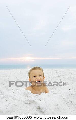 Little boy at the beach, smiling at camera, portrait View Large Photo Image Stock Photography - Little boy at the beach, smiling at camera, portrait. Fotosearch