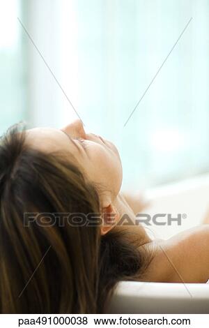 Woman in bathtub, leaning head against the side, close-up, cropped view View Large Photo Image Stock Photo - Woman in bathtub, leaning head against the side, close-up, cropped view. Fotosearch