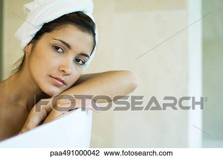 Woman resting head against side of bathtub, looking away, close-up View Large Photo Image Stock Image - Woman resting head against side of bathtub, looking away, close-up. Fotosearch