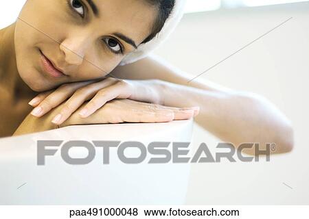 Woman resting head on side of bathbub, looking at camera, close-up View Large Photo Image Stock Photo - Woman resting head on side of bathbub, looking at camera, close-up. Fotosearch