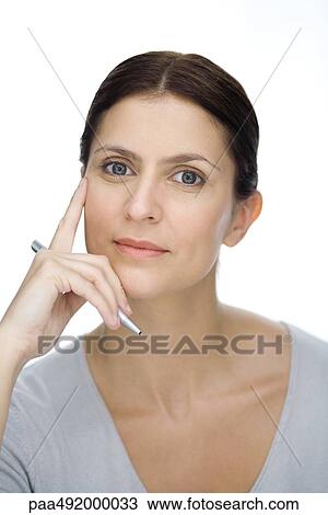 Businesswoman holding pen, looking at camera, portrait View Large Photo Image Stock Image - Businesswoman holding pen, looking at camera, portrait. Fotosearch