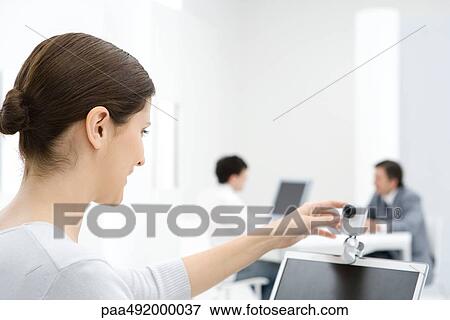 Businesswoman using webcam in office View Large Photo Image Stock Photo - Businesswoman using webcam in office. Fotosearch