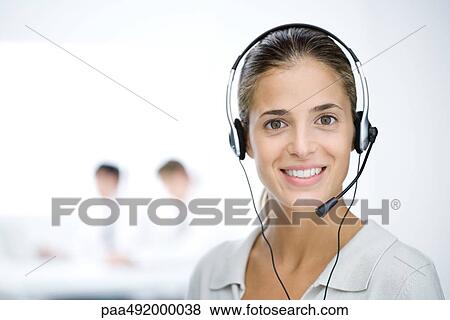 Customer service representative with headset, smiling at camera, portrait View Large Photo Image Stock Photo - Customer service representative with headset, smiling at camera, portrait. Fotosearch