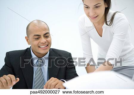 Two business associates working together, smiling View Large Photo Image Stock Photo - Two business associates working together, smiling. Fotosearch