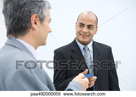Two businessmen exchanging business card View Large Photo Image Stock Photography - Two businessmen exchanging business card. Fotosearch