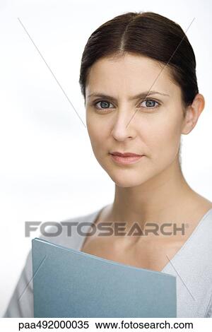 Woman holding file, looking at camera, portrait View Large Photo Image Stock Photography - Woman holding file, looking at camera, portrait. Fotosearch