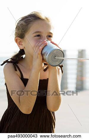 Girl talking into tin can phone View Large Photo Image Stock Image - Girl talking into tin can phone. Fotosearch