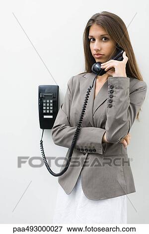 Teen girl using landline phone, looking at camera View Large Photo Image Stock Photo - Teen girl using landline phone, looking at camera. Fotosearch