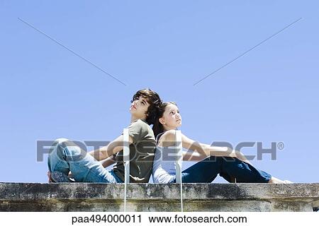 Brother and sister sitting back to back, looking up and away View Large Photo Image Stock Image - Brother and sister sitting back to back, looking up and away. Fotosearch