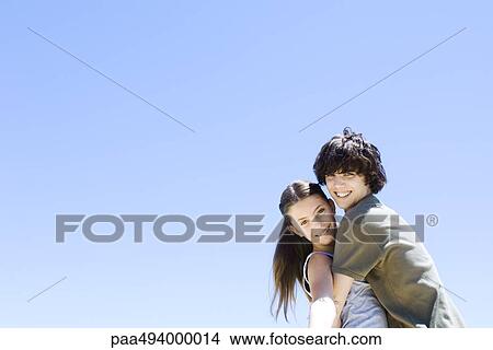 Picture - Brother hugging his sister, smiling at camera. Fotosearch