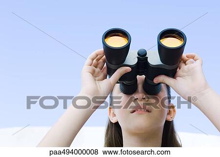 Stock Photo - Preteen girl looking up through binoculars. Fotosearch