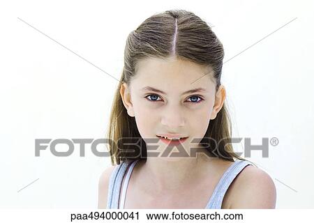 Stock Image - Preteen girl smiling at camera, portrait. Fotosearch