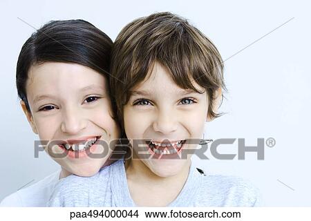 Sister behind her brother head resting on his shoulder, smiling at camera, portrait View Large Photo Image Picture - Sister behind her brother head resting on his shoulder, smiling at camera, portrait. Fotosearch