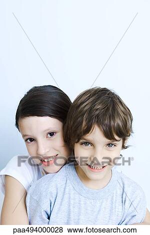 Sister hugging her brother from behind, smiling at camera, portrait View Large Photo Image Stock Photo - Sister hugging her brother from behind, smiling at camera, portrait. Fotosearch