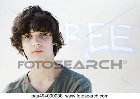 Teenage boy looking at camera, in front of graffiti View Large Photo Image Stock Photo - Teenage boy looking at camera, in front of graffiti. Fotosearch