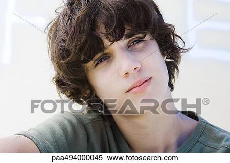 Stock Photography - Teenage boy looking away, head tilted, portrait. Fotosearch