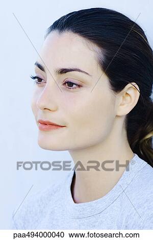 Stock Image - Woman looking away, close-up, portrait. Fotosearch
