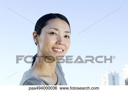 Stock Photograph - Woman smiling, portrait. Fotosearch