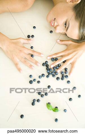 Fresh blueberries scattered across counter, young woman spreading hands over them View Large Photo Image Stock Image - Fresh blueberries scattered across counter, young woman spreading hands over them. Fotosearch