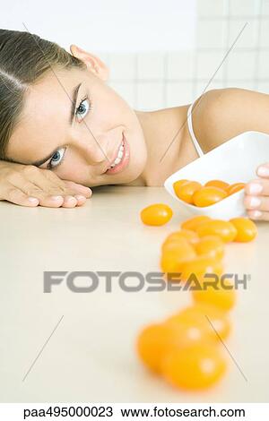 Woman resting head on counter, spilling yellow cherry tomatoes View Large Photo Image Stock Image - Woman resting head on counter, spilling yellow cherry tomatoes. Fotosearch