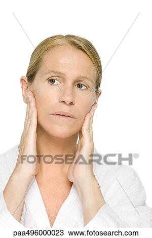 Mature woman touching face, looking away View Large Photo Image Stock Image - Mature woman touching face, looking away. Fotosearch