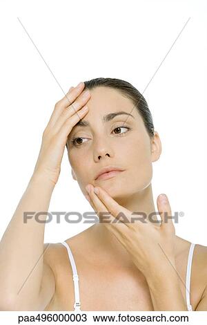 Stock Image - Woman touching face, portrait. Fotosearch