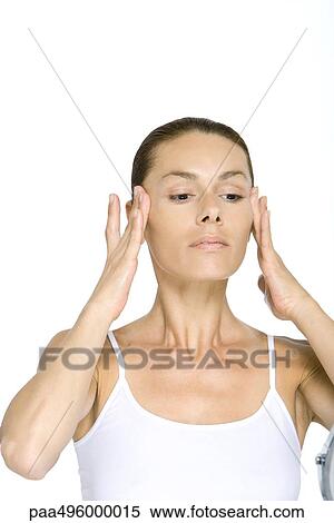 Woman touching face, pulling back cheeks View Large Photo Image Stock Photography - Woman touching face, pulling back cheeks. Fotosearch