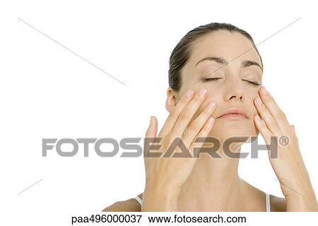 Woman touching face with both hands, eyes closed View Large Photo Image Stock Photo - Woman touching face with both hands, eyes closed. Fotosearch
