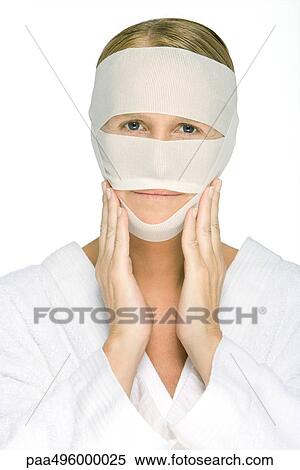 Woman with bandaged face, touching cheeks, looking at camera View Large Photo Image Stock Photography - Woman with bandaged face, touching cheeks, looking at camera. Fotosearch