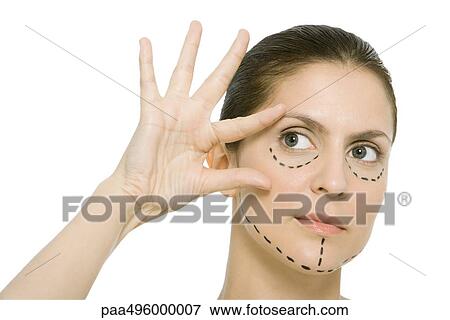 Woman with plastic surgery markings on face, touching face, looking away View Large Photo Image Stock Photo - Woman with plastic surgery markings on face, touching face, looking away. Fotosearch