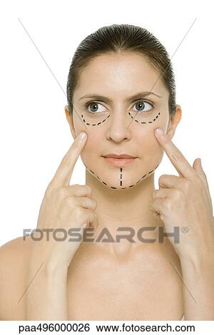 Woman with plastic surgery markings on face, touching cheeks, looking away View Large Photo Image Stock Photograph - Woman with plastic surgery markings on face, touching cheeks, looking away. Fotosearch