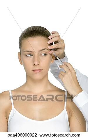 Young woman receiving Botox injection View Large Photo Image Stock Image - Young woman receiving Botox injection. Fotosearch