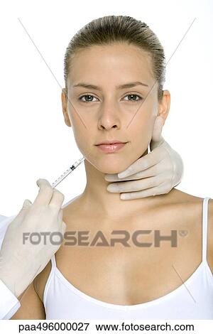 Young woman receiving collagen injection, looking at camera View Large Photo Image Stock Photo - Young woman receiving collagen injection, looking at camera. Fotosearch
