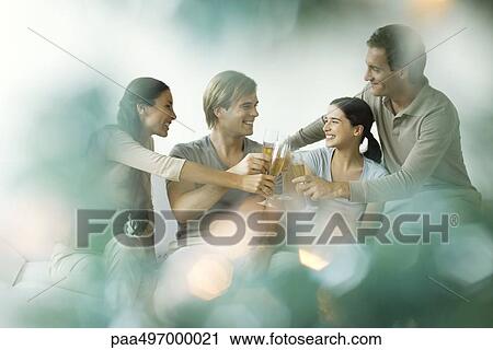 Adult friends clinking champagne glasses, smiling View Large Photo Image Stock Image - Adult friends clinking champagne glasses, smiling. Fotosearch