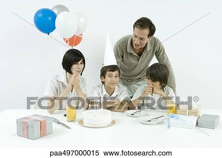 Boy having birthday party with family, looking at camera View Large Photo Image Stock Photography - Boy having birthday party with family, looking at camera. Fotosearch